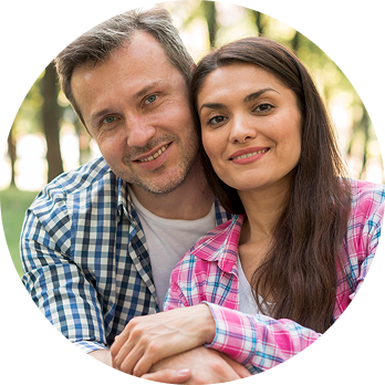 Happy couple sitting outdoors together in a park