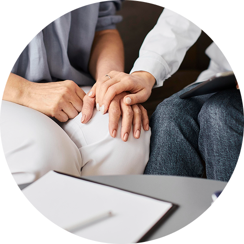 Therapist offering comfort and support with a couple during session